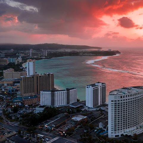 City skyline at sunset with red sky in background