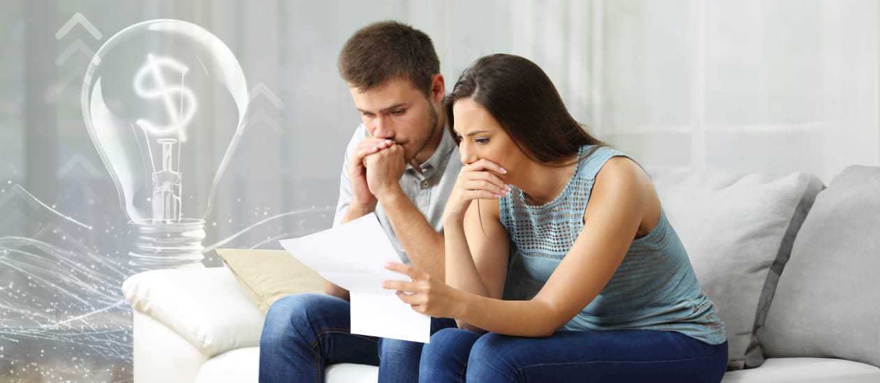 A couple looking over their utility bill and wondering how theyll pay for it