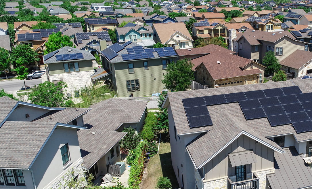 Aerial view of residential homes with solar panels on the roof