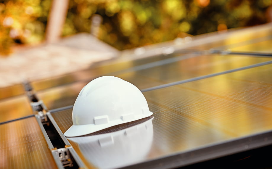 hard hat sitting on top of a solar panel
